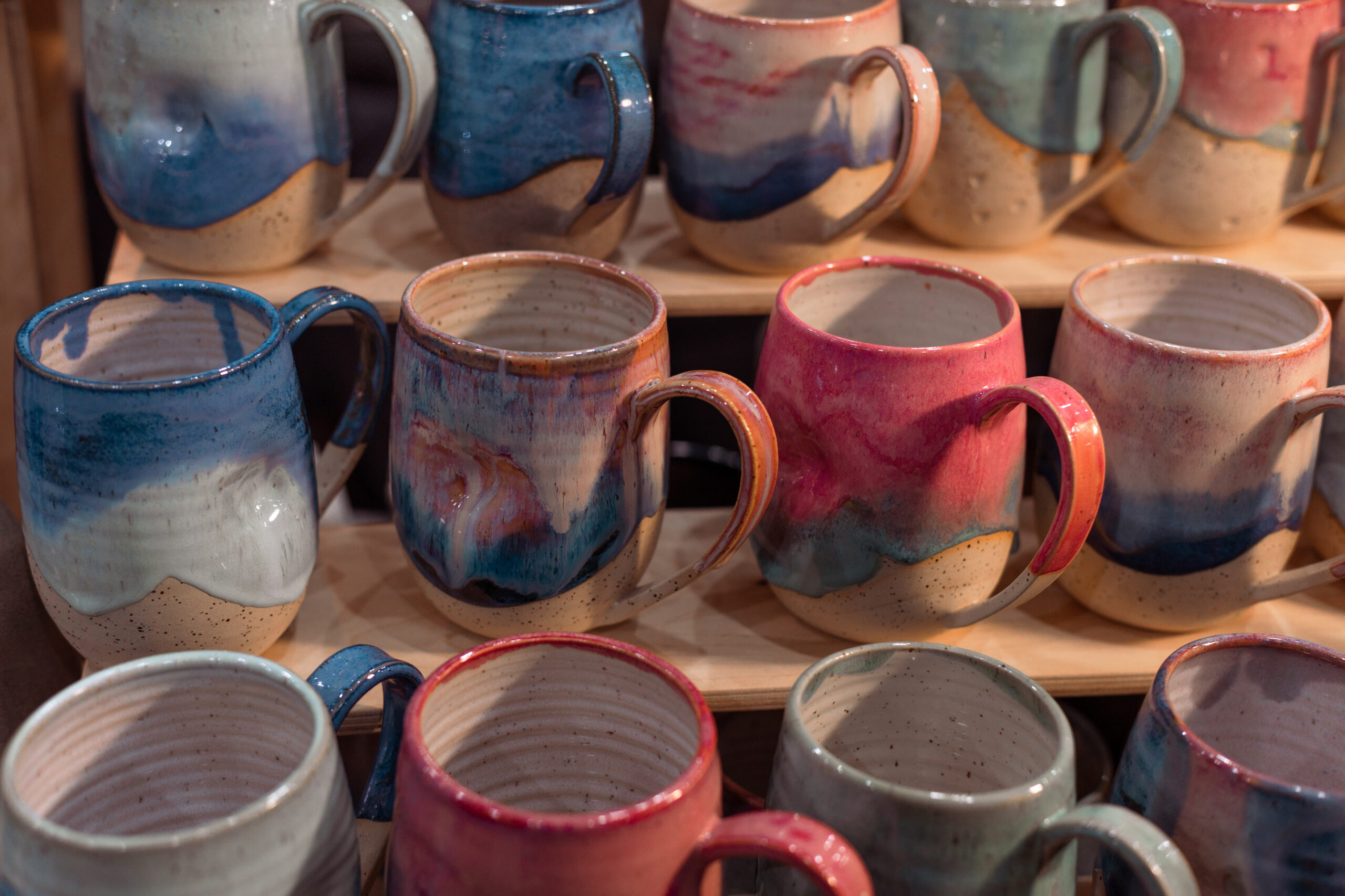 Handmade ceramic mugs in coastal colors